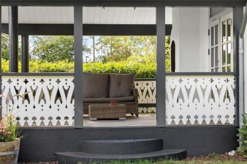 a porch with a couch on a white fence at 1359-N-Hillerod-Lykkesholmvej-20 in Hillerød