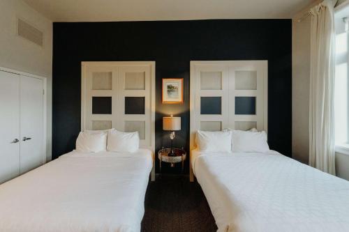 two beds sitting next to each other in a bedroom at Mercer Hotel Downtown; BW Premier Collection in Stratford