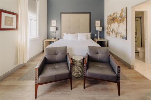 a hotel room with a bed and two chairs at Mercer Hotel Downtown; BW Premier Collection in Stratford