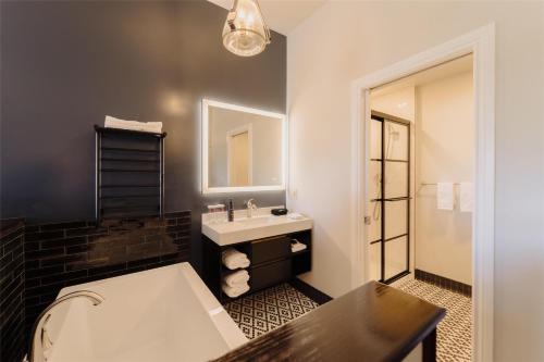 a bathroom with a sink and a mirror at Mercer Hotel Downtown; BW Premier Collection in Stratford