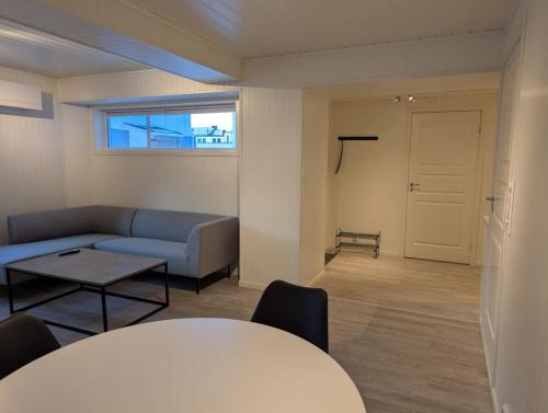 a living room with a couch and a table at Central Station Retreat in Narvik