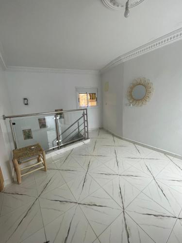 a living room with a tiled floor and a bench at Dar Chefchauen in Chefchaouene