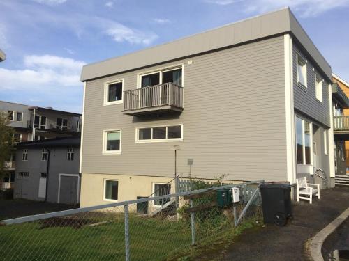 a house with a balcony on the side of it at Central Station Retreat in Narvik