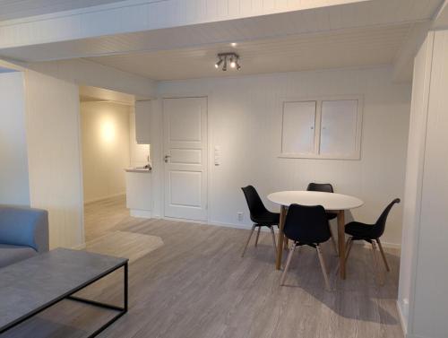 a living room with a table and chairs at Central Station Retreat in Narvik