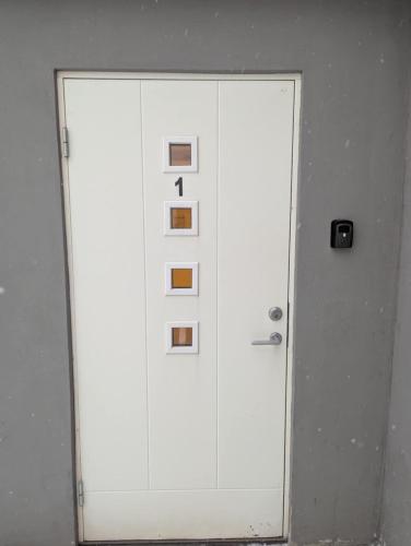 a white door with the number one on it at Central Station Retreat in Narvik