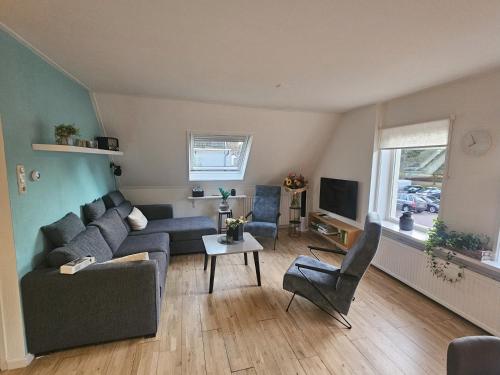 a living room with a couch and a tv at Appartement "de grote Vesting" Elburg in Elburg