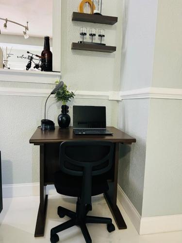 a desk with a laptop computer on top of it at Hogar in Port Richey