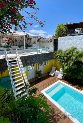 a house with a swimming pool and a staircase at Pousada Duna Beach in Jericoacoara