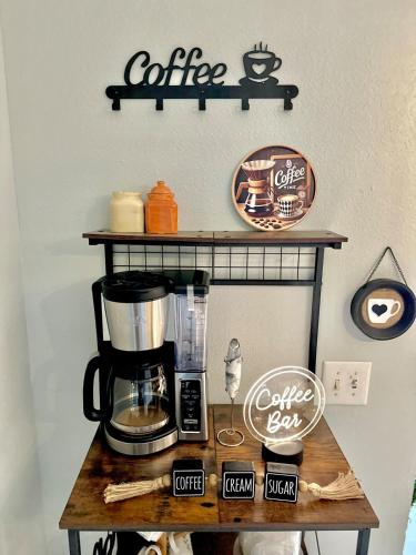 a coffee bar with a coffee maker on a table at Hogar in Port Richey