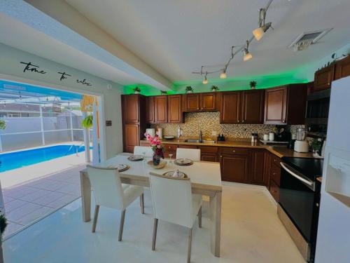a kitchen with a table and chairs and a pool at Hogar in Port Richey