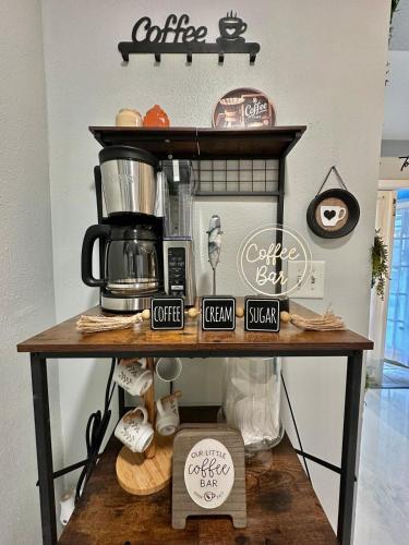 a table with a coffee maker on top of it at Hogar in Port Richey