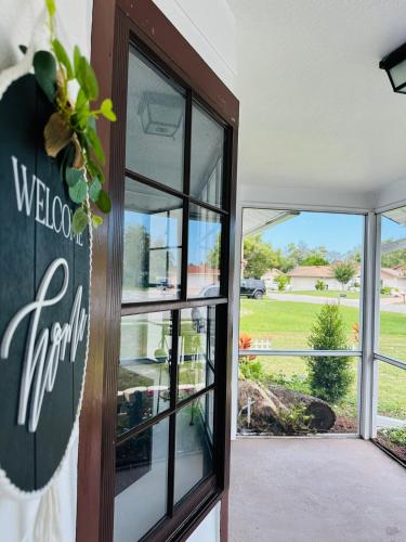 a door to a store with a view of a yard at Hogar in Port Richey