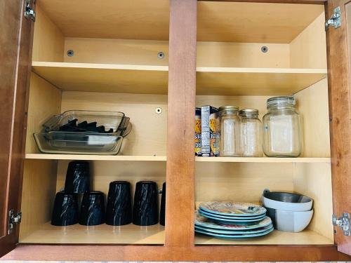 a cabinet filled with dishes and jars and plates at Hogar in Port Richey