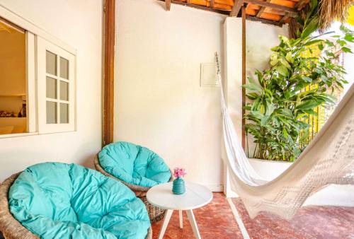 a room with two chairs and a table at Pousada Duna Beach in Jericoacoara