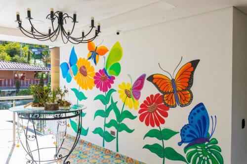 a wall with butterflies painted on it at Hotel Bahia Del Faro in Guatapé