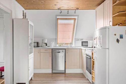 a kitchen with white appliances and a window at 70421-Ulfborg-Kirkevej-2-1-sal in Thorsminde