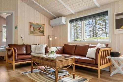a living room with a couch and a table at 30036-Ulfborg-Oster-Skovvej-149 in Sønder Nissum