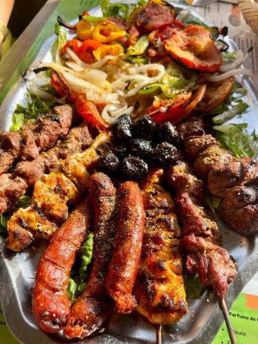 a plate of food with sausage and a salad at Sun, Pool & Beach - Imi Ouaaddar Getaway in Imi Ouaddar