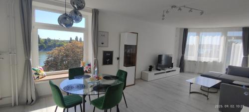 ブダペストにあるDuna Panorama -two-bedroom apartment with terraceのテーブルと椅子と窓のあるリビングルーム