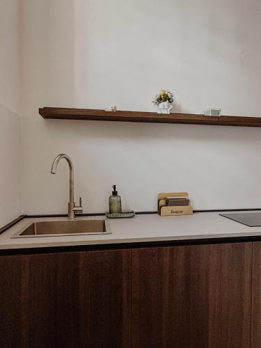 a kitchen with a sink and a counter top at I pensieri di Carolina - Palazzo Carolina in Pescara