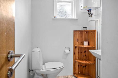 a bathroom with a white toilet and a sink at 30140-Ulfborg-Valmuevej-290 in Vang