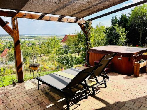 a table and two chairs on a patio with a view at Panorama Residence Pákozd in Pákozd