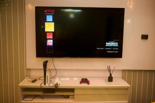 a flat screen tv hanging on a wall at Cremyark Homes in Benin City