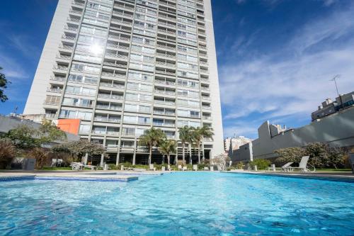 a large swimming pool in front of a tall building at Complejo Quartier San Telmo & Spa in Buenos Aires