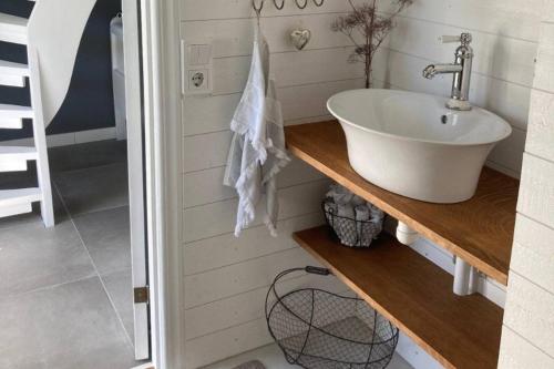 a bathroom with a sink on a wooden counter at Traumhaus mit Seegrundstück in Holmsjö