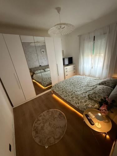 a bedroom with a large bed and a mirror at Roma sweet house in Rome