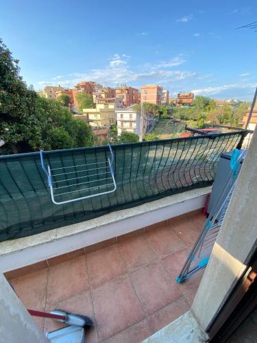 a balcony with chairs and a view of a city at Roma sweet house in Rome