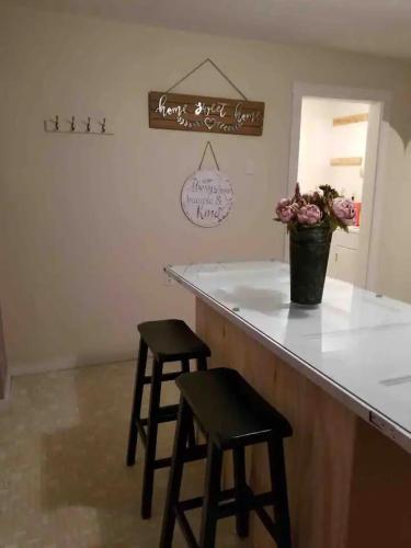 a bar with two stools sitting at a counter at Relaxing Rustic Oasis II, Unit B - 6 minute walk to Downtown! Cyclists Welcome! in Cumberland
