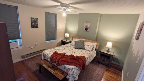 a bedroom with a bed with a laptop on it at Relaxing Rustic Oasis II, Unit B - 6 minute walk to Downtown! Cyclists Welcome! in Cumberland