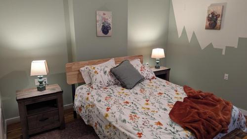 a bedroom with a bed with two night stands and two lamps at Relaxing Rustic Oasis II, Unit B - 6 minute walk to Downtown! Cyclists Welcome! in Cumberland