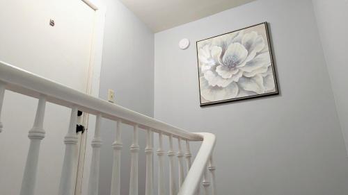 a picture of a flower on a wall next to a staircase at Relaxing Rustic Oasis II, Unit B - 6 minute walk to Downtown! Cyclists Welcome! in Cumberland