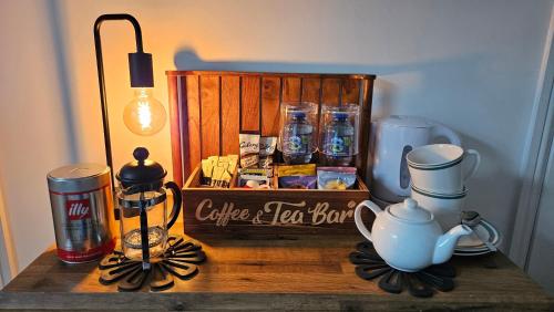 a table with a wooden crate with a tea box on it at Induli Holywood - Private Luxury Double Room near Belfast in Cultra