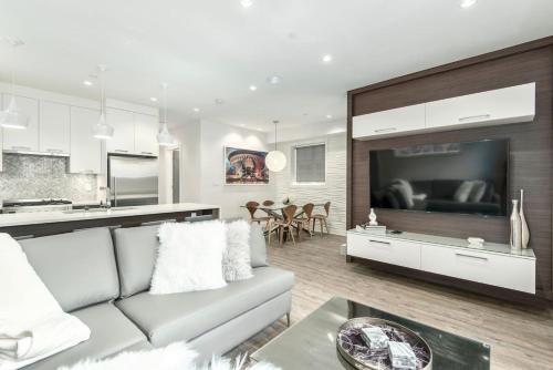 a living room with a couch and a large television at Kitsilano Retreat at Private 3 Bed with Parking and BBQ in Vancouver