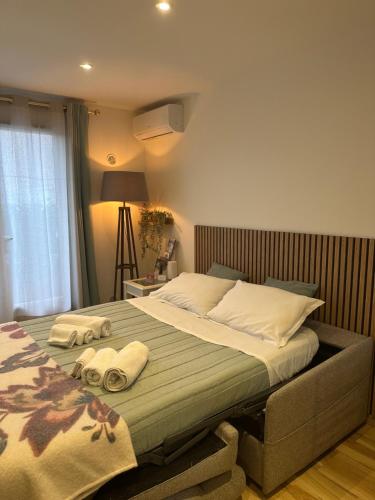 a bedroom with a large bed with towels on it at Studio in Cogolin
