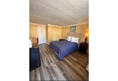 a hotel room with a bed and a television at Central Myrtle Beach Stay Walk to Ocean in Myrtle Beach