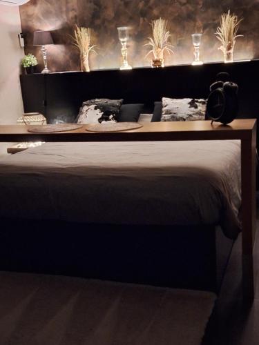 a bedroom with a large bed with lights on it at Maison Beau in Zonhoven