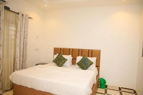 a bedroom with a bed with white sheets and pillows at Cremyark Homes in Benin City