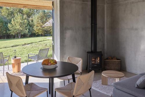 a dining room with a table and a stove at Sauseriai - Inspired by Nature S2 in Prystovai