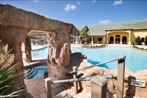 a resort with a swimming pool and a building at 5BR Paradise Palms Townhome POOL by Disney in Kissimmee