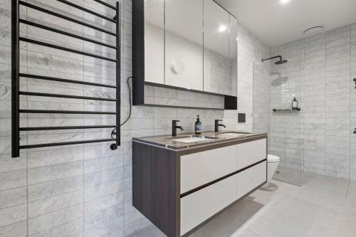a bathroom with a sink and a toilet at Luxury 3 storey residence in Melbourne