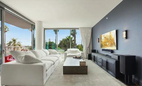 ロサンゼルスにあるSuperb Two Bedroom Condo in Santa Monicaの白いソファとテレビのあるリビングルーム