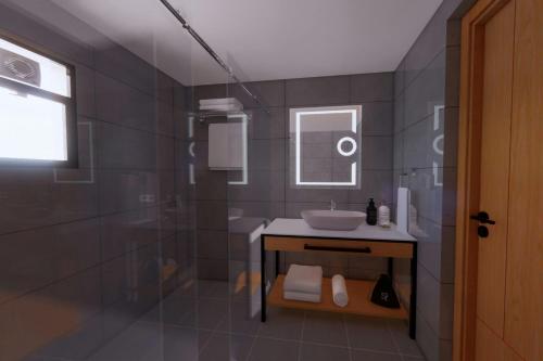 a bathroom with a sink and a shower at Protea Hotel by Marriott Kinshasa in Kinshasa