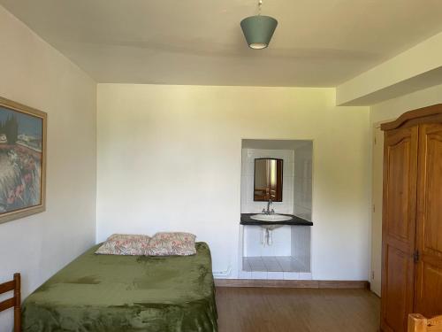 a bedroom with a bed and a mirror on the wall at Séjour à la campagne in Crévin