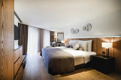 a hotel room with a bed and a television at Madison Taipei, a Tribute Portfolio Hotel in Taipei