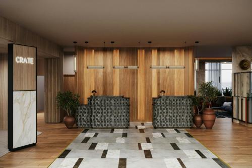 a lobby with wooden walls and potted plants at Courtyard by Marriott Quito Airport in Quito