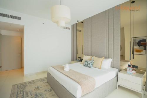 a bedroom with a large white bed in a room at Exclusive Home with Private Beach in Dubai